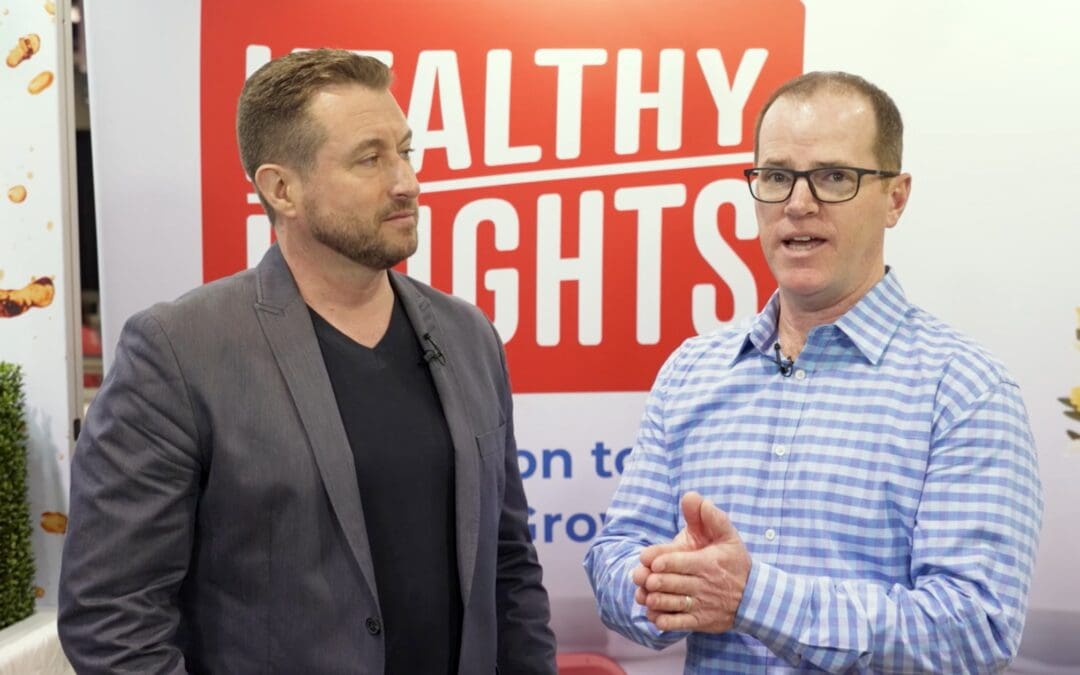 steve turner with bryce in front of healthy heights banner at expo